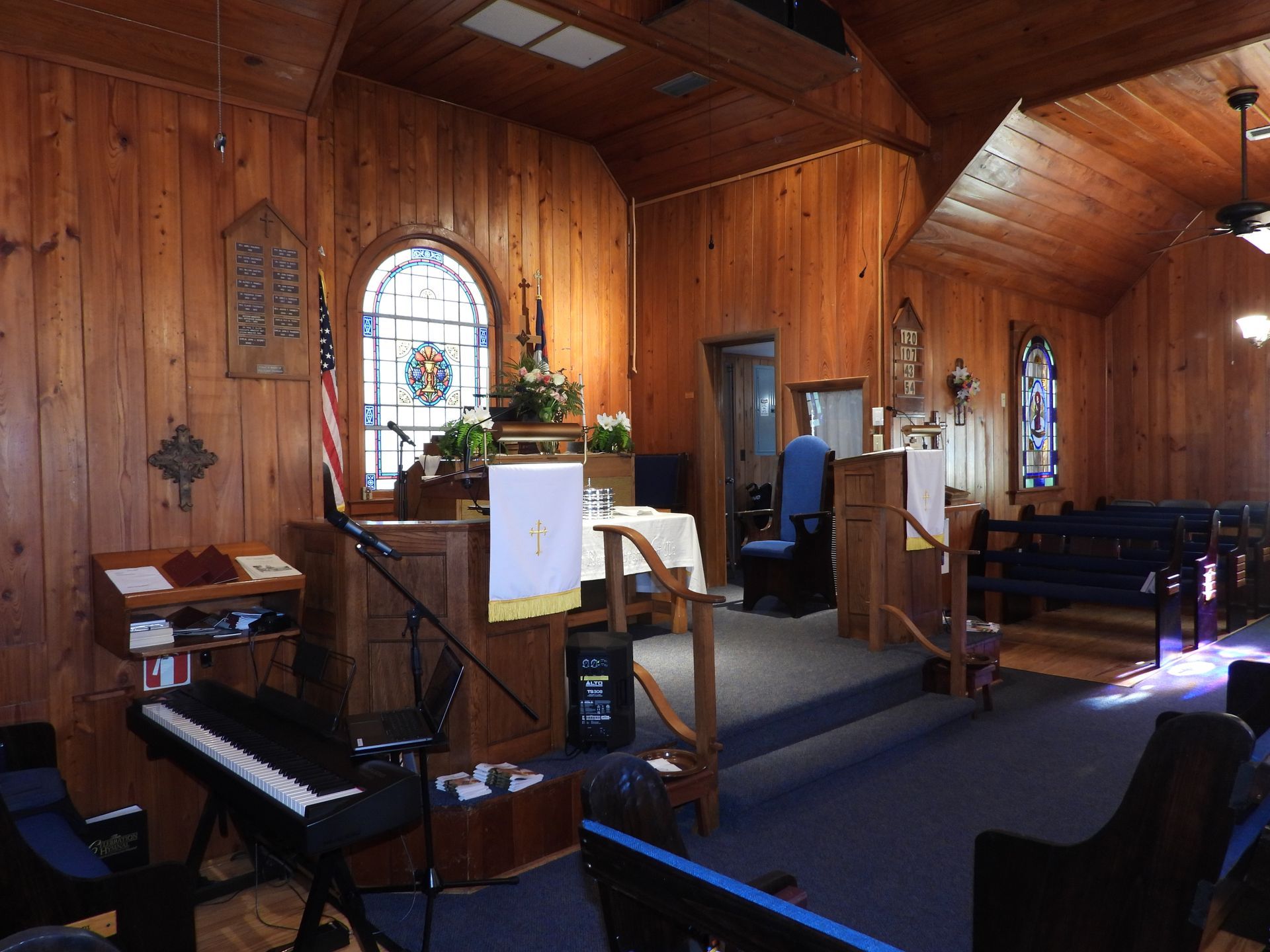 A church with a piano and a stained glass window