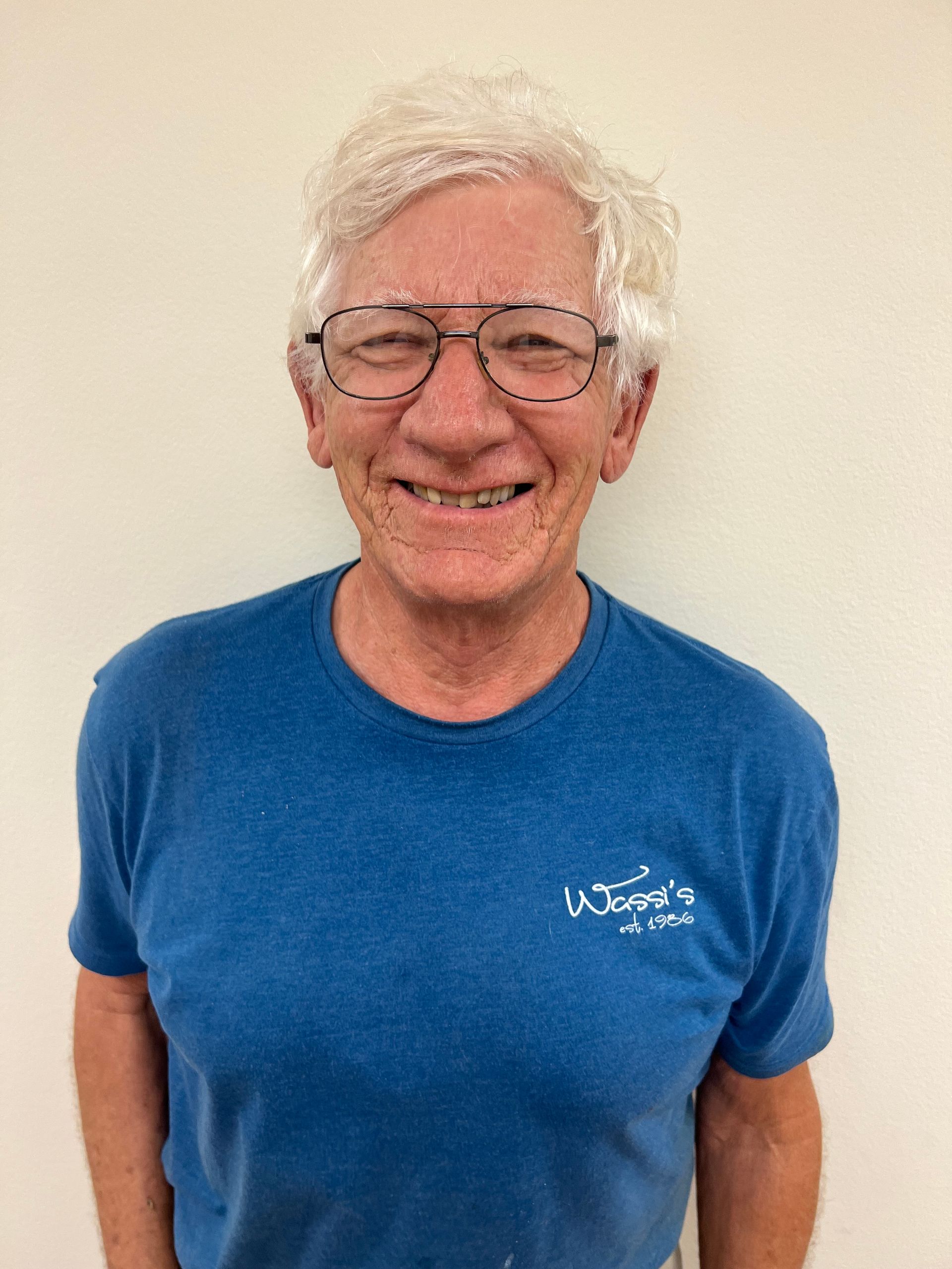 A blue icon of a person without a face on a white background.