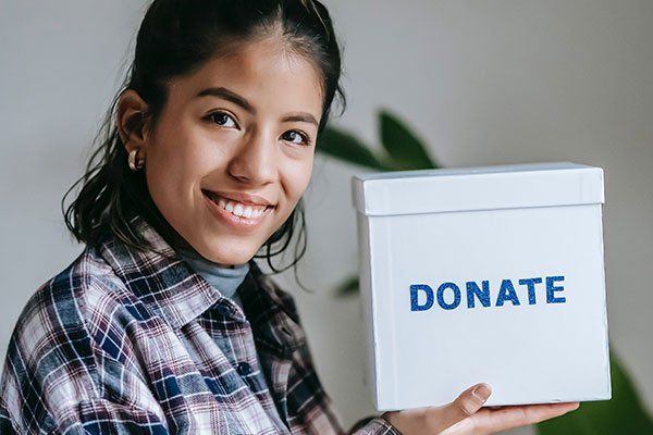 a lady with a donate box Truth Tara™
