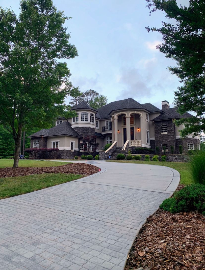 A large house with a driveway leading to it