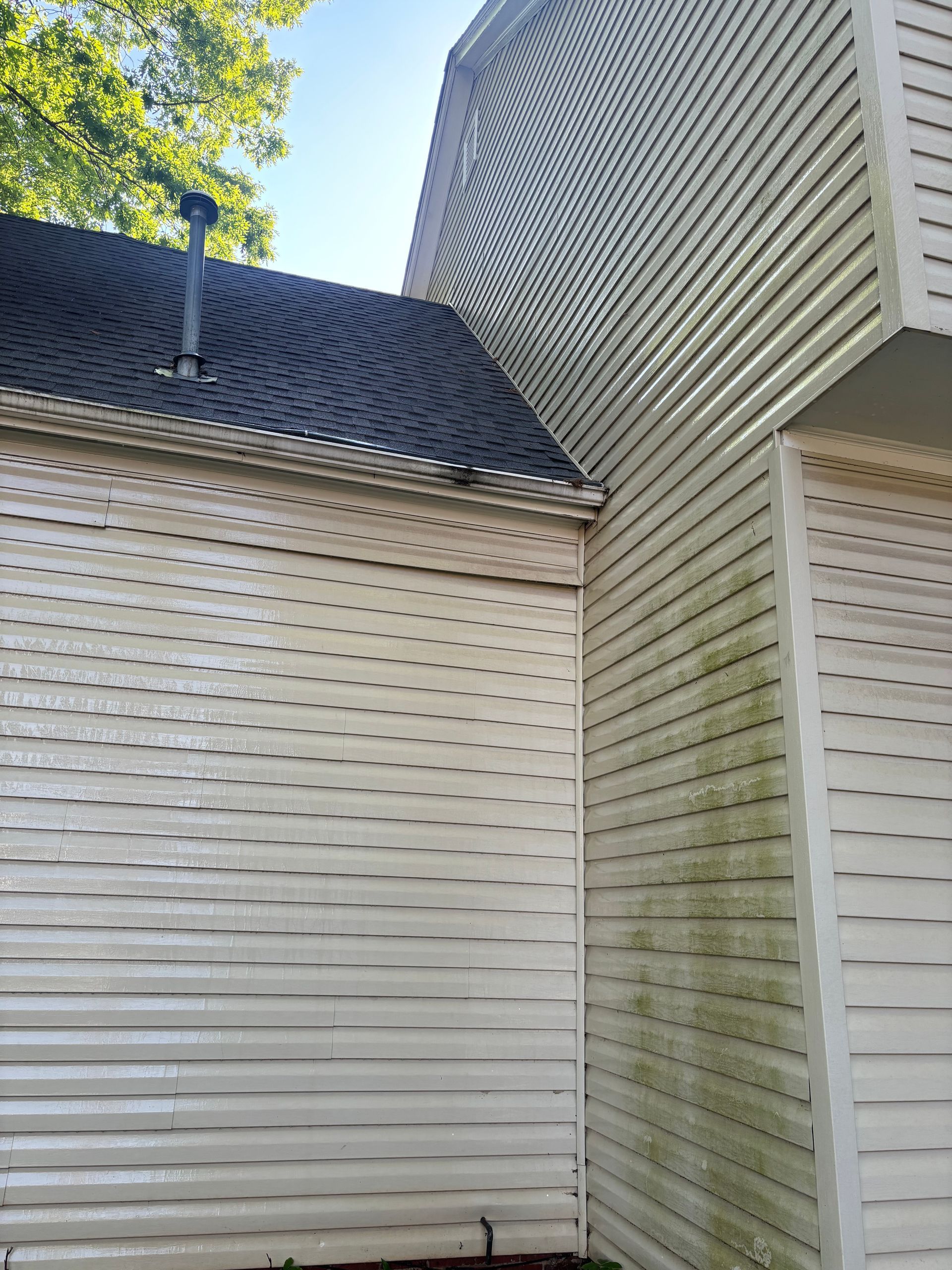 A house with a dirty siding and a window.