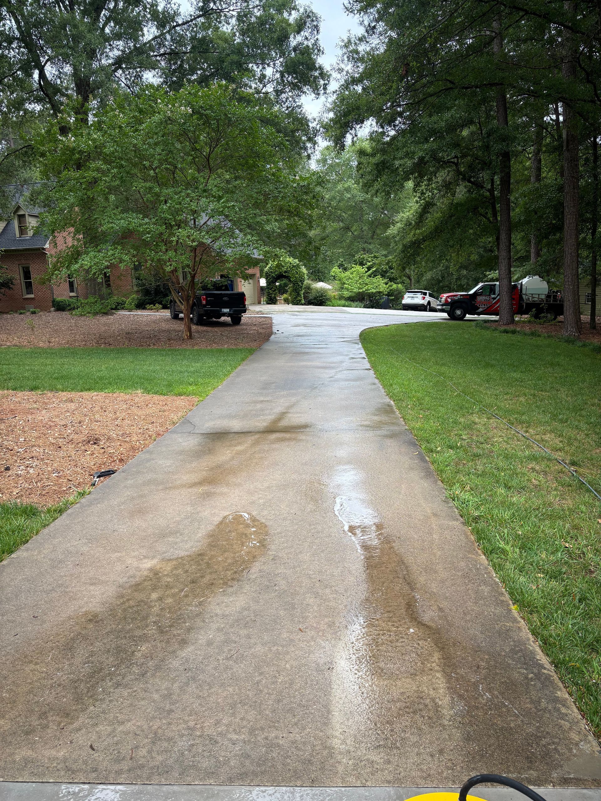 A before and after photo of a concrete driveway with grass growing out of it.