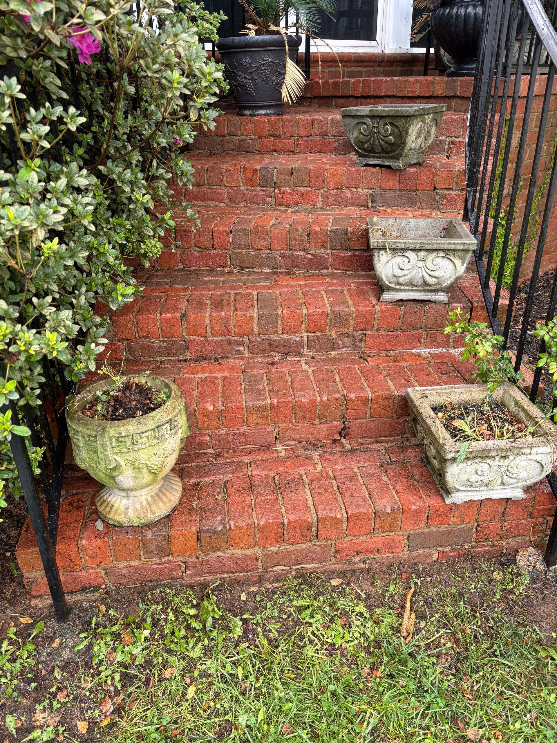 The side of a house with a wooden fence and a lot of windows.