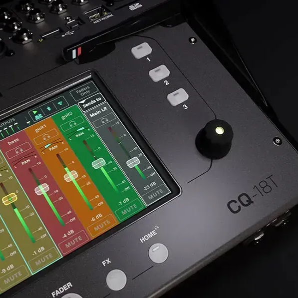 Black speaker on green grass outdoors with a metal grill, logo at the top.