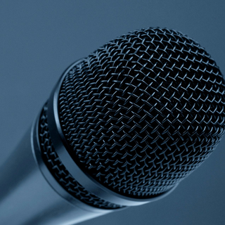 Person carrying a black speaker labeled 