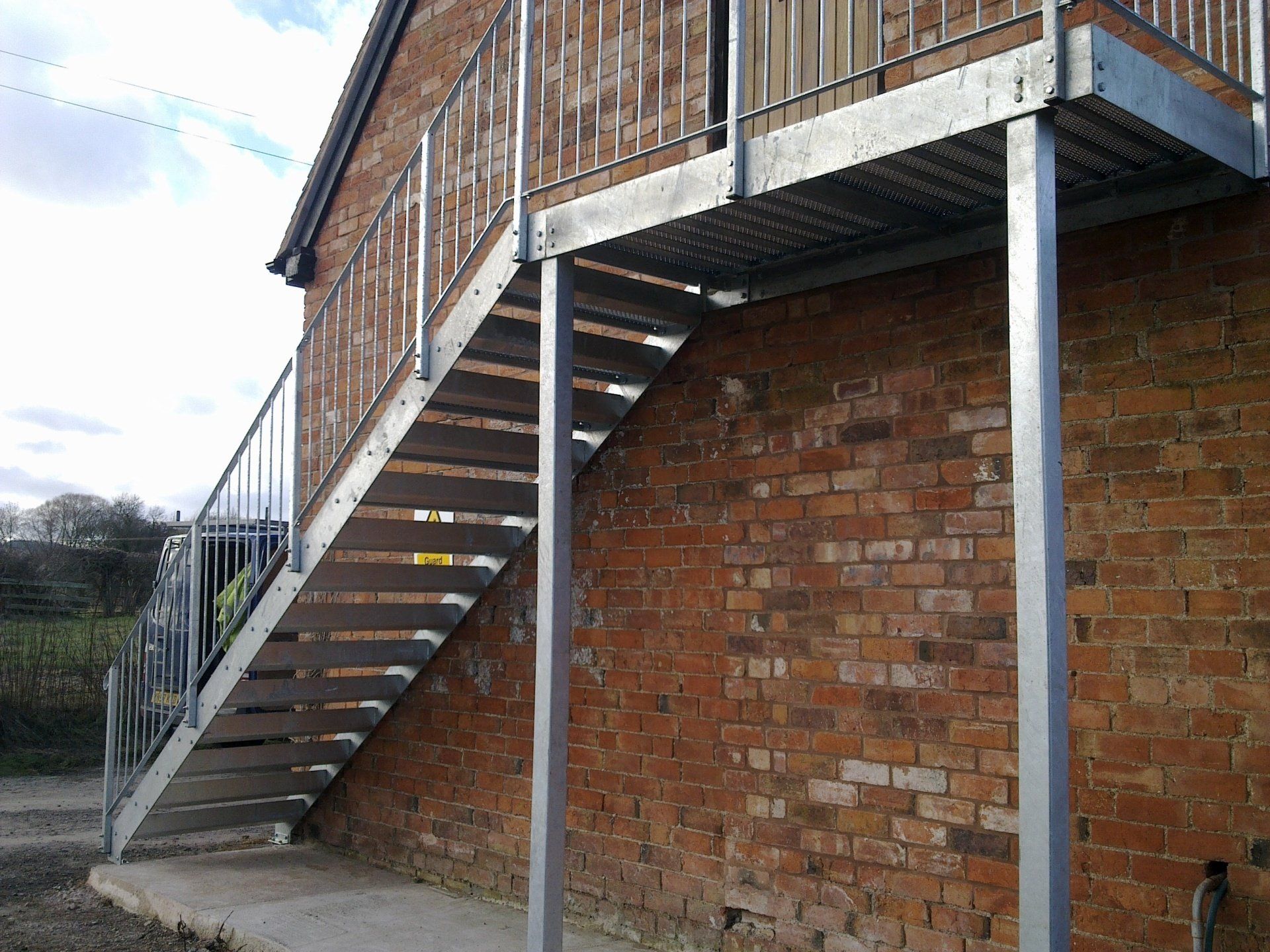 Metal exterior staircase attached to a brick building.