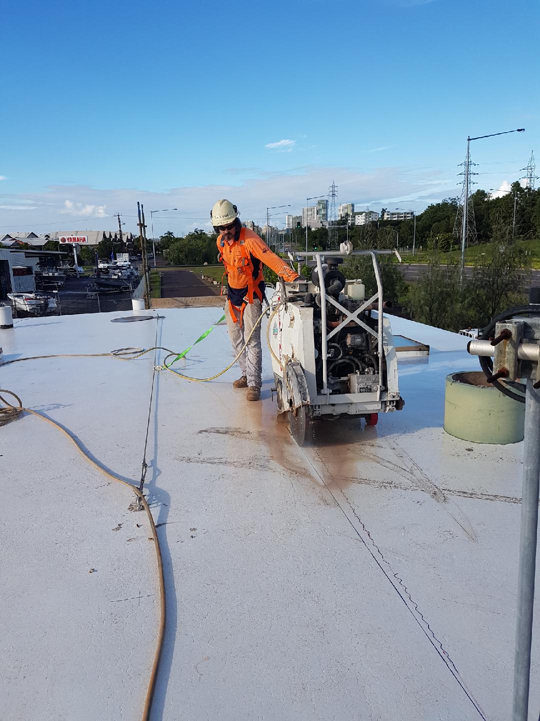 Man Uses Concrete Cutter Machine — Super City Concrete Cutting In Darwin, NT