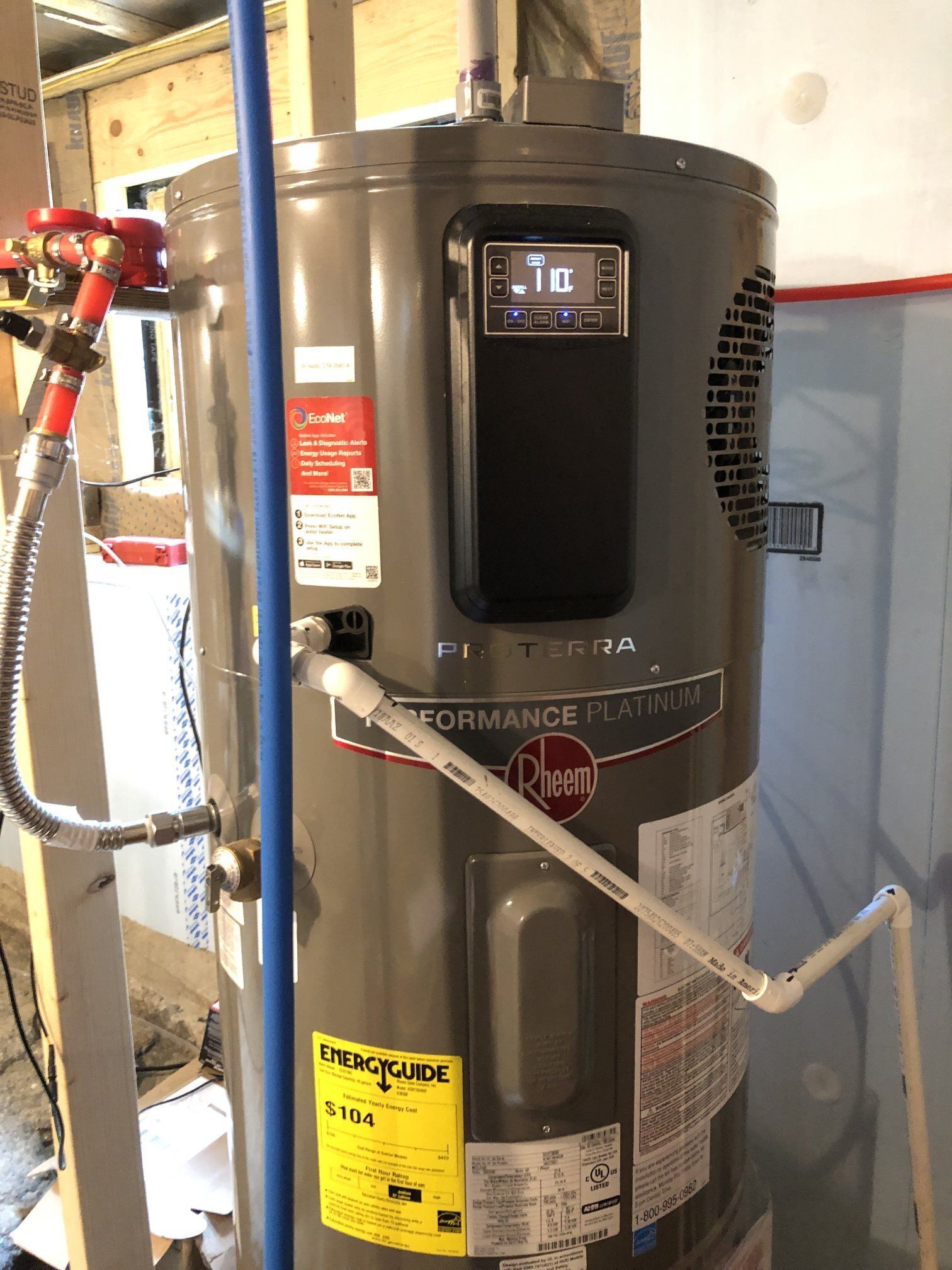 A water heater and a water filter are in a basement.