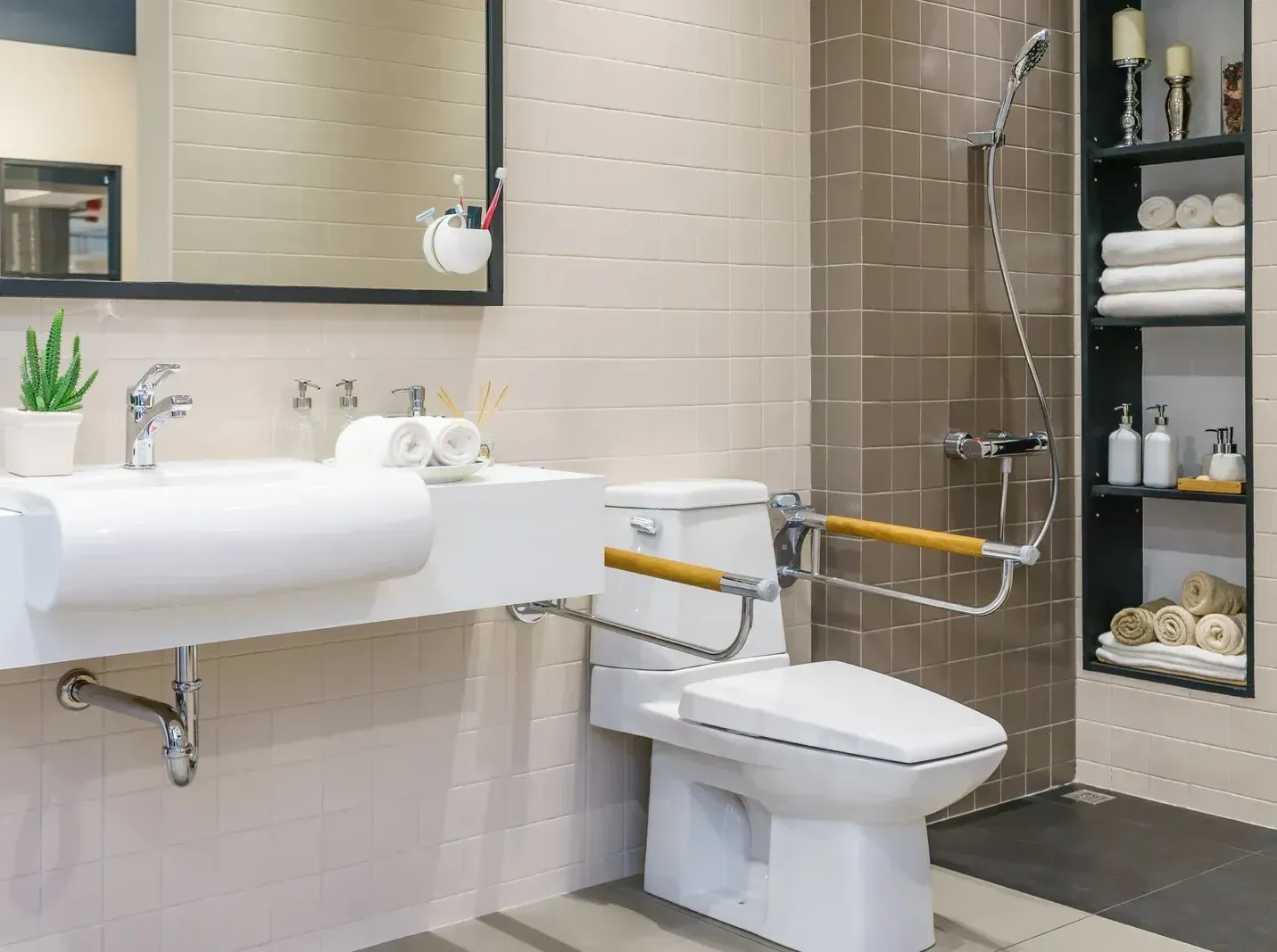 A bathroom with a toilet , sink , mirror and shower.