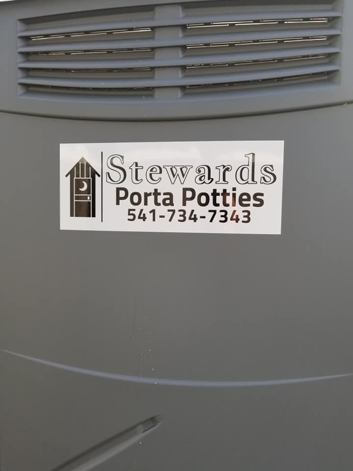 A sticker on a gray porta-potty: 