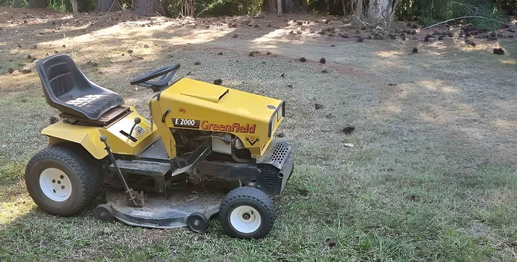 A Yellow Lawn Mower Is Sitting On Top Of A Lush Green Field — Eclipse Hire In Edmonton, QLD
