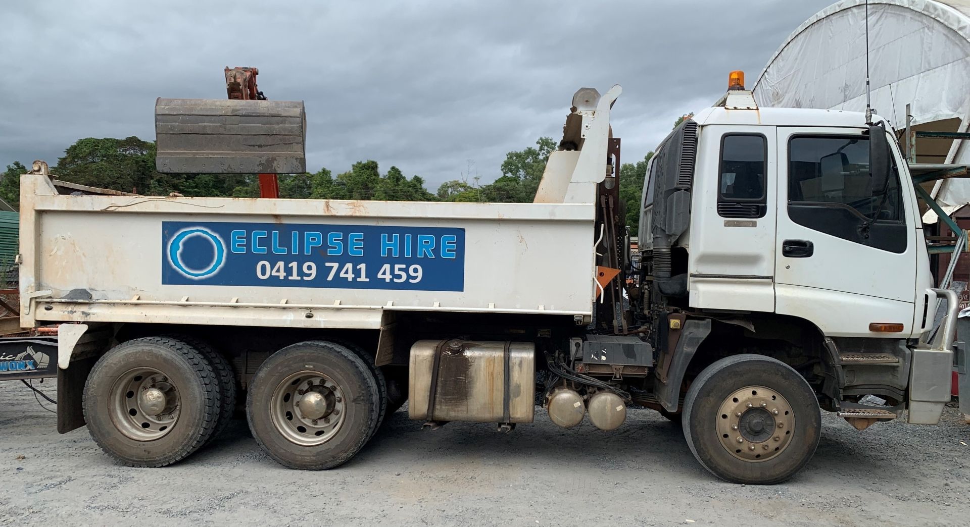 A Truck Parked In A Parking Lot With The Business Logo On The Side — Eclipse Hire In Edmonton, QLD