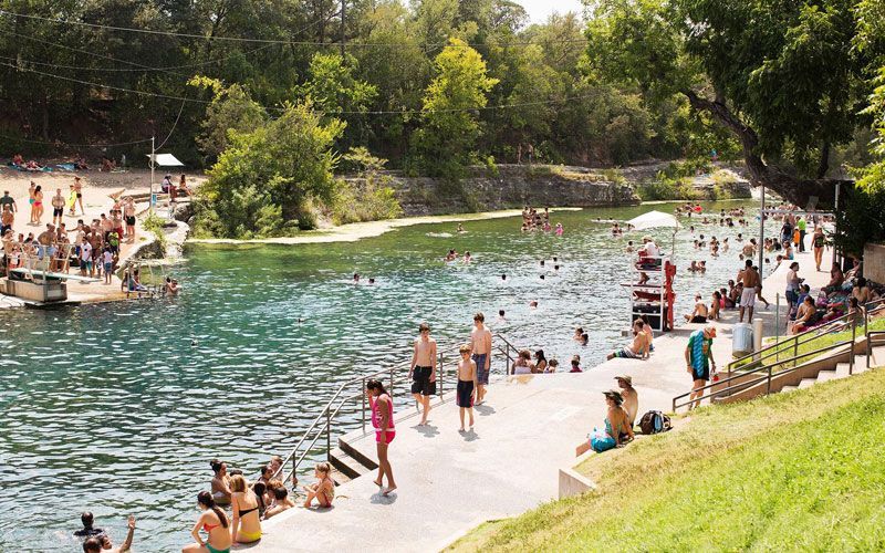 A group of people are swimming in a lake.