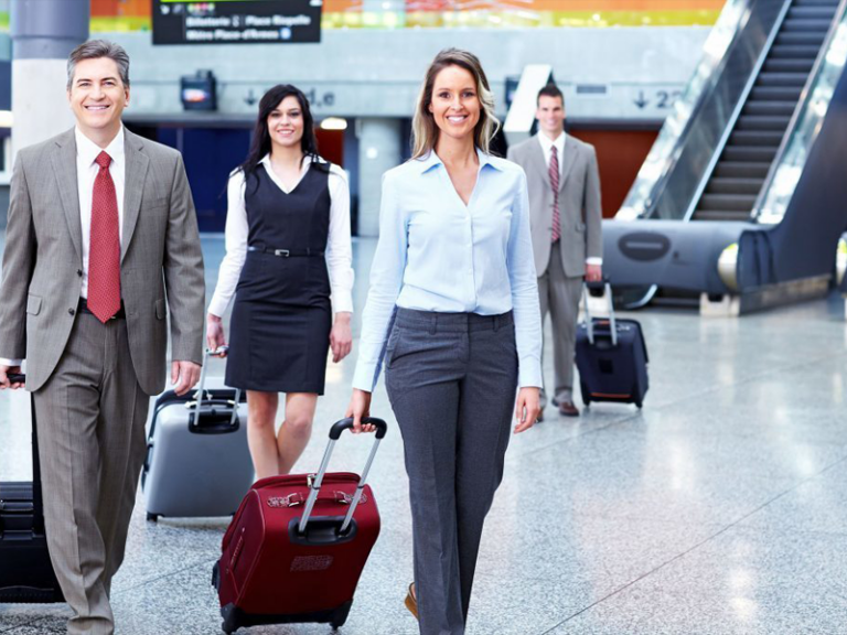 A group of people walking with luggage in an airport