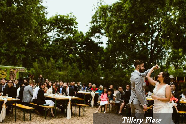A bride and groom are dancing at their wedding reception at tillery place