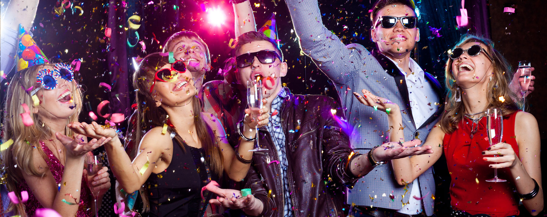A group of people are standing next to each other at a party.