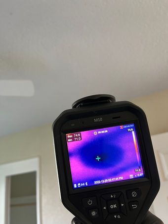 Thermal camera showing a cold spot on a ceiling, likely indicative of a leak or insulation issue.