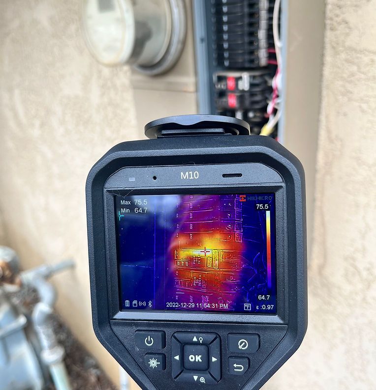 Thermal camera showing a hot electrical panel, potentially indicating an issue.