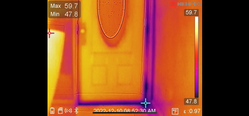 Thermal image of a door, with temperatures ranging from warm (yellow) to cool (purple), showing potential heat loss.