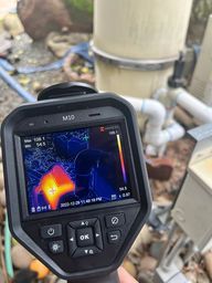 Thermal camera pointed at pool equipment showing heat spots.