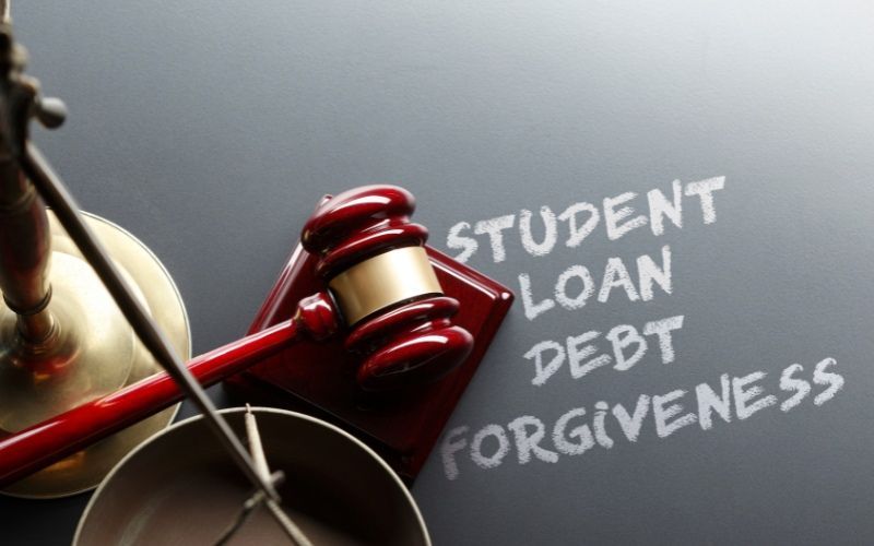 A judge's gavel on a chalkboard with the words student loan debt forgiveness written on it.