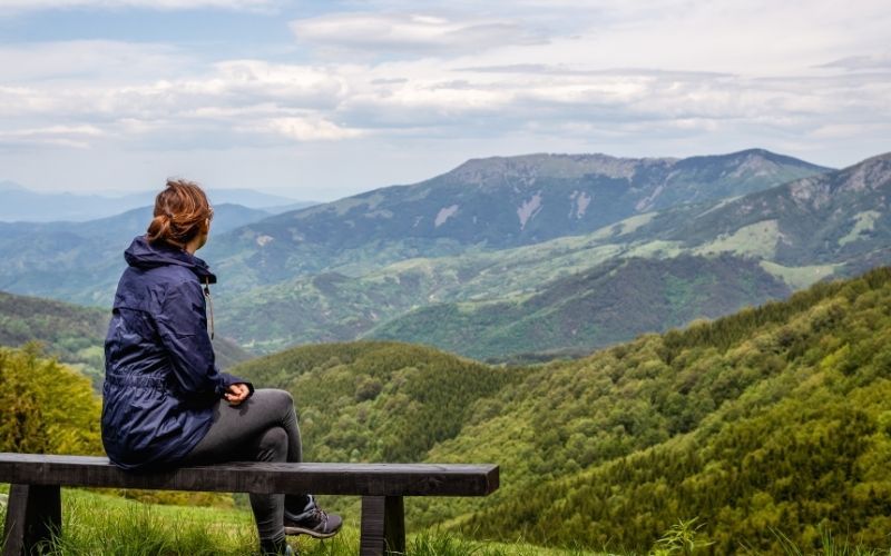 Person contemplating a mountain vista symbolizing Pacific Debt Relief alternatives to bankruptcy
