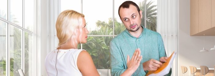 A debt collector and a woman talking while the man is holding a debt record.