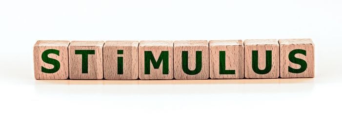 The word stimulus is written on wooden blocks on a white background emphasizing Who Qualifies and How Much to Expect.