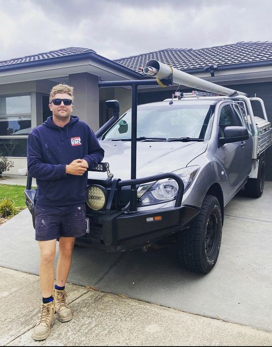 Plumber in front of Pick up truck service