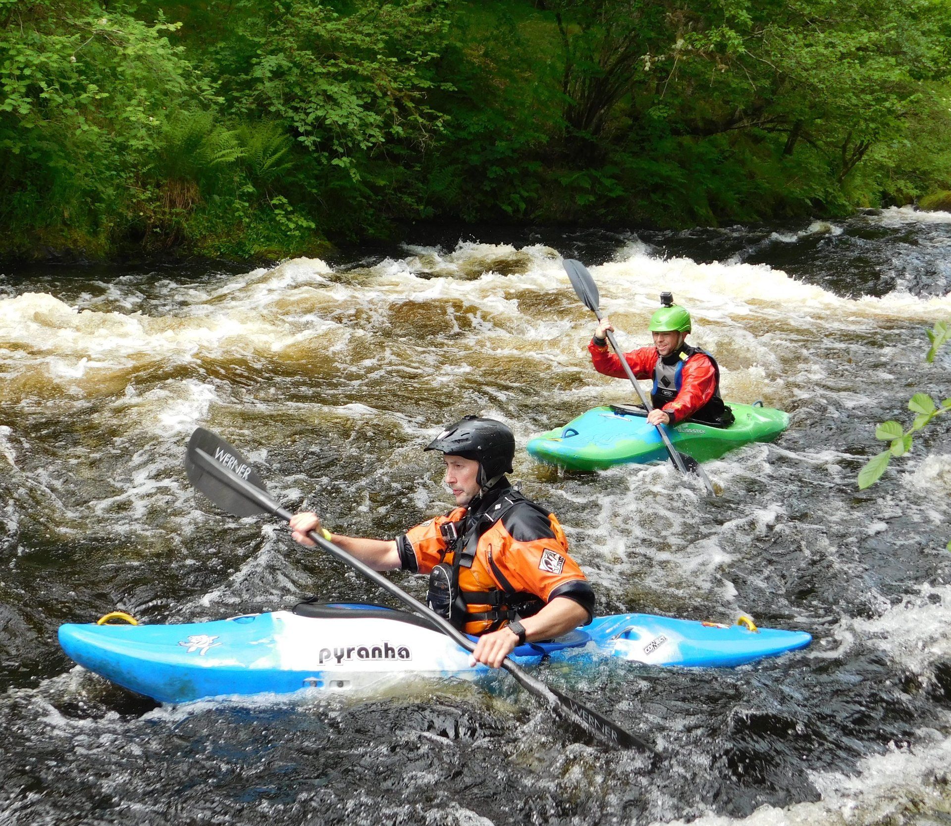 Coached groups kayaking on the Tryweryn