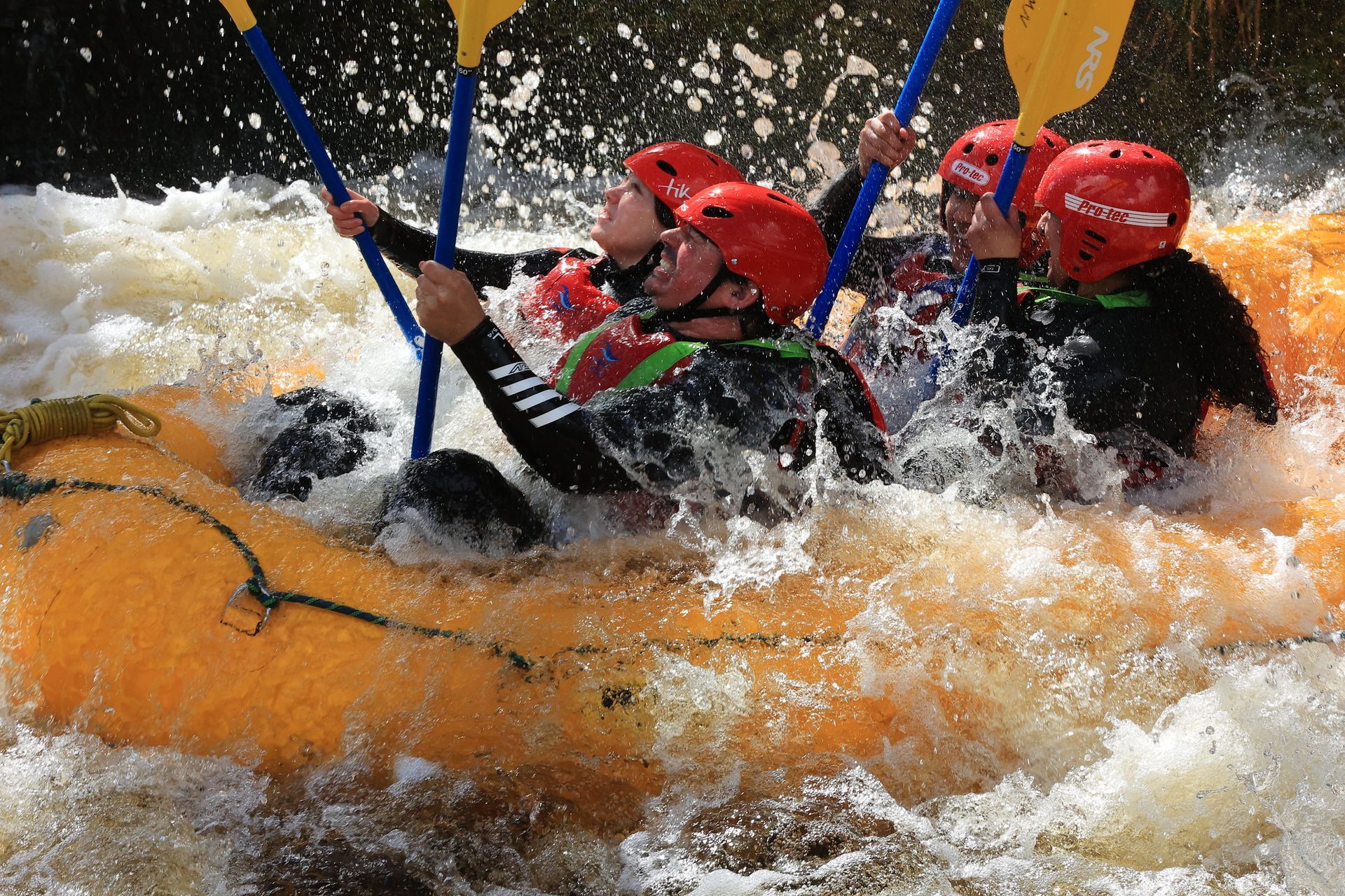 Four rafters are drenched in the cool Afon Tryweryn on a scorching hot day.