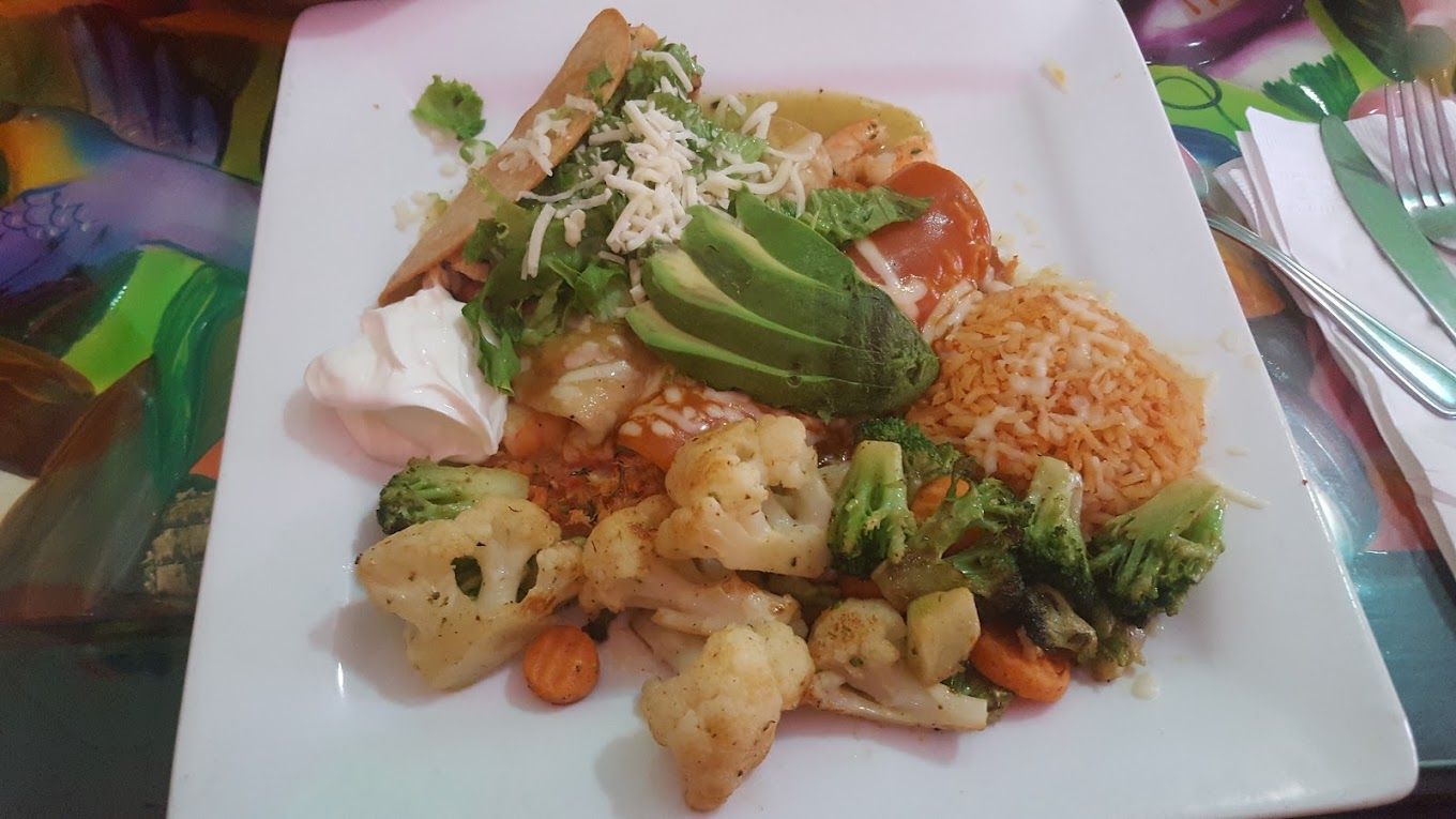 A white plate topped with a variety of vegetables and rice.