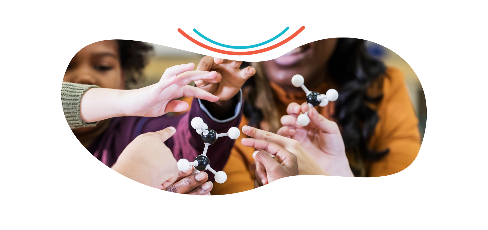 a group of people are holding a model of a molecule in their hands .