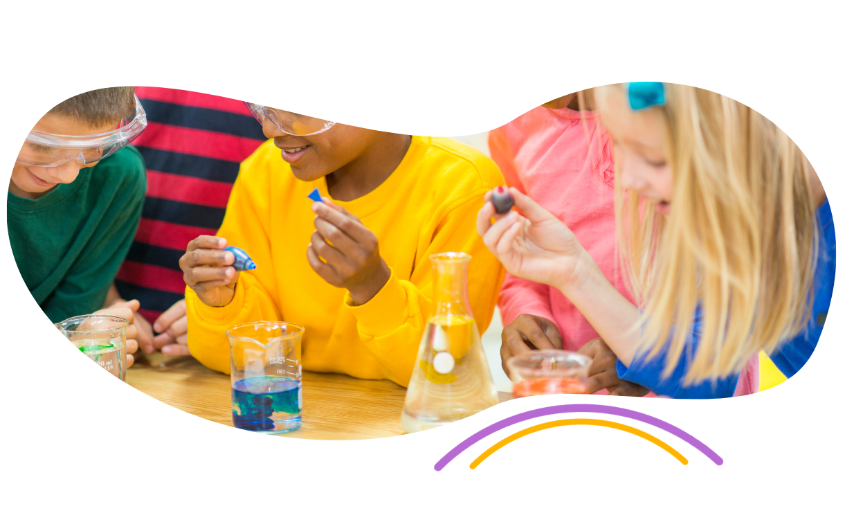 a group of children are sitting at a table doing a science experiment .