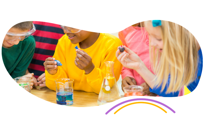 a group of children are sitting at a table doing a science experiment .