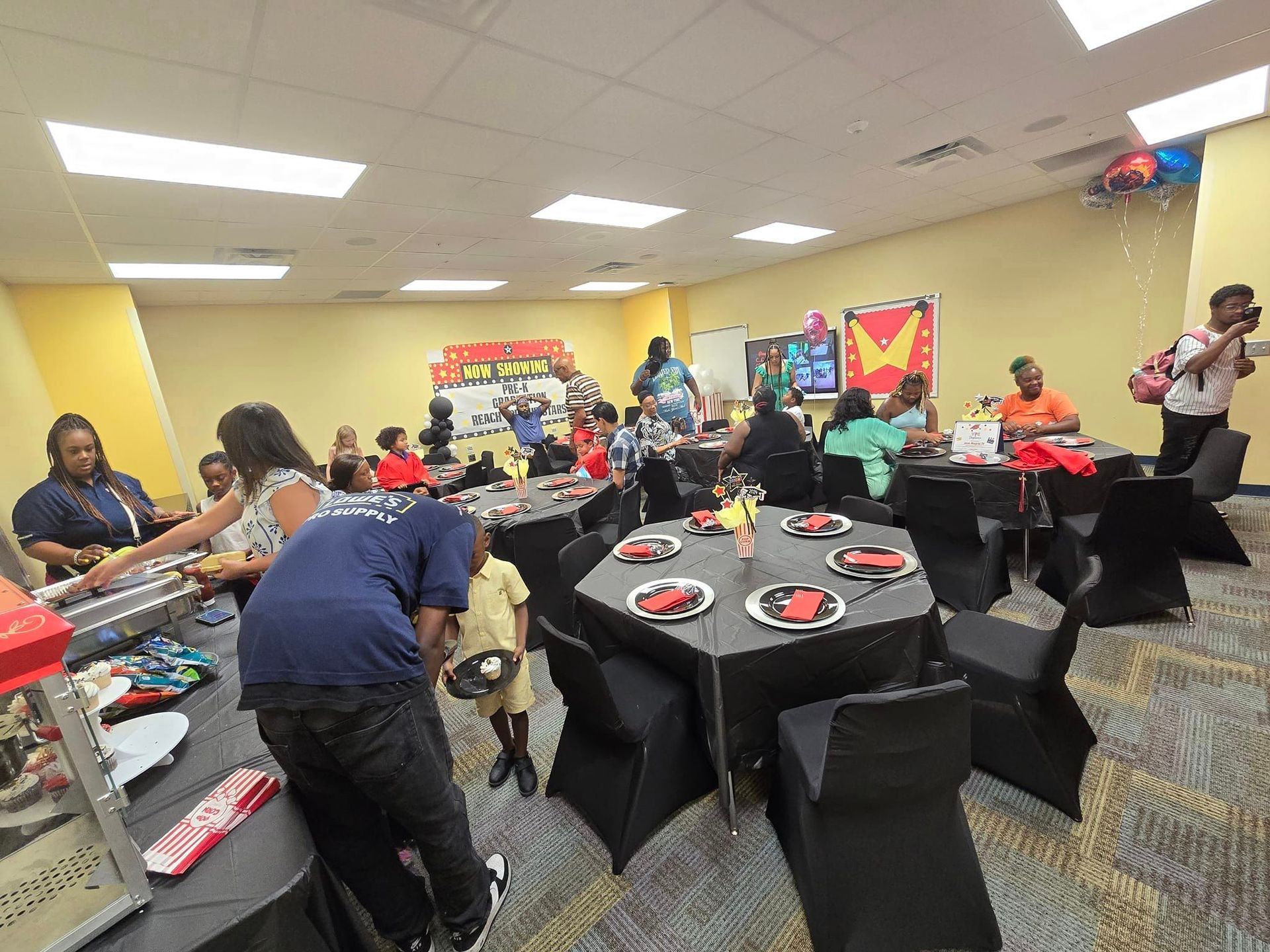 A group of people are sitting at tables in a room.