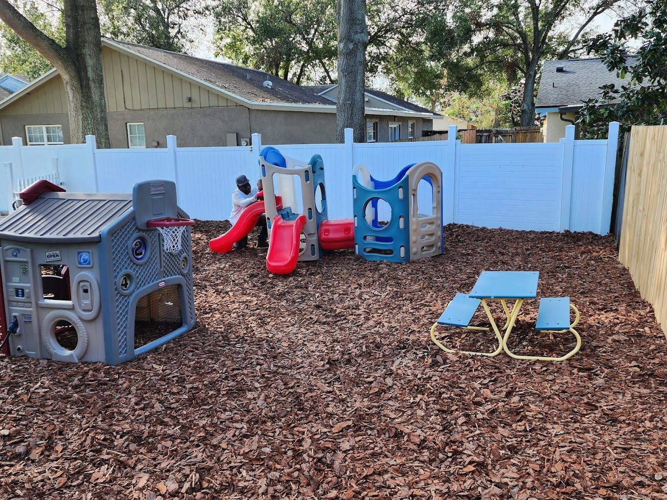 A group of children are sitting on the floor in a circle playing cards.