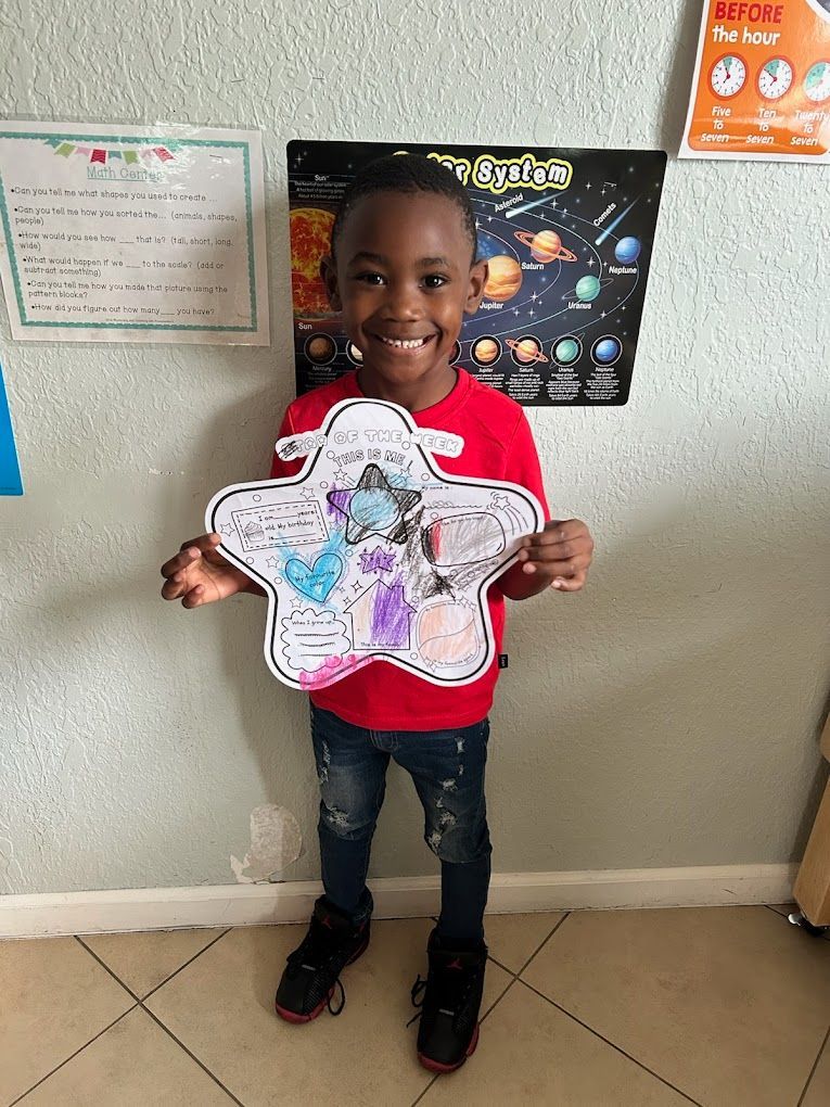 A group of children are sitting on the floor in a classroom with a teacher.