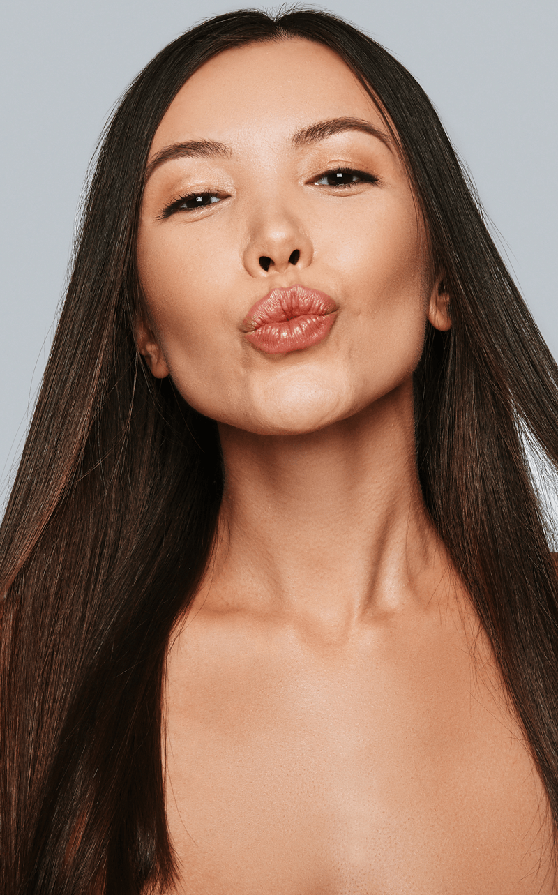 Young Asian woman blowing a kiss