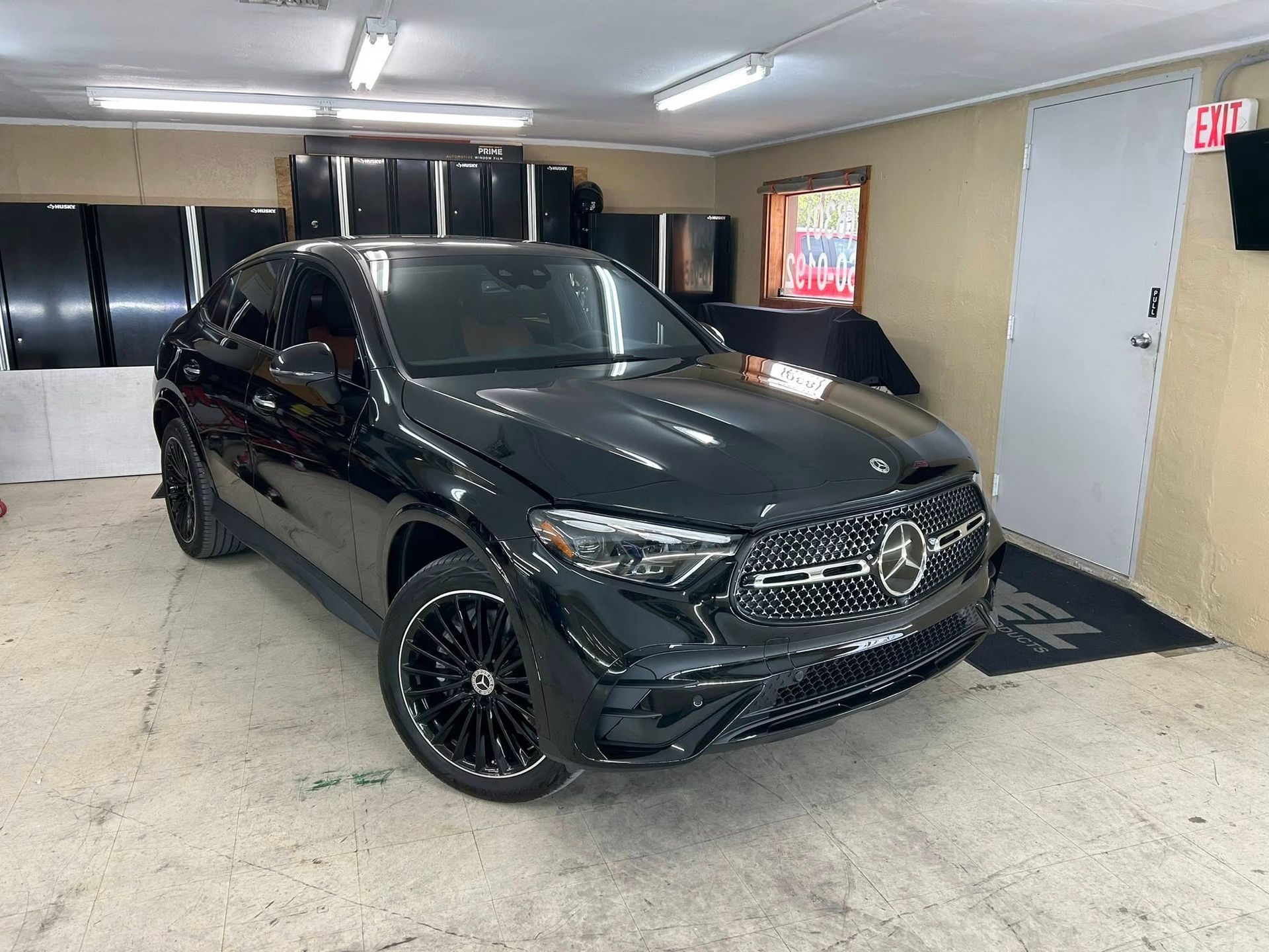 Black Mercedes SUV in a garage.