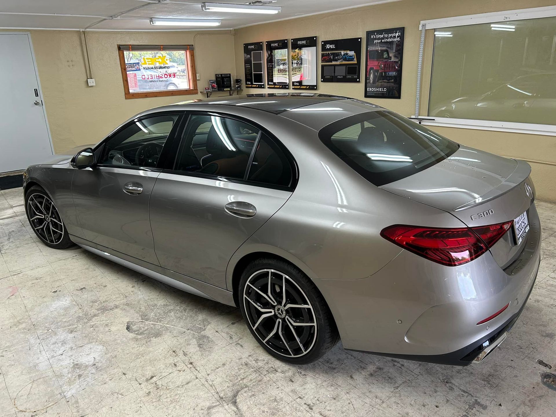 Silver Mercedes sedan in a garage, showcasing window tinting options.