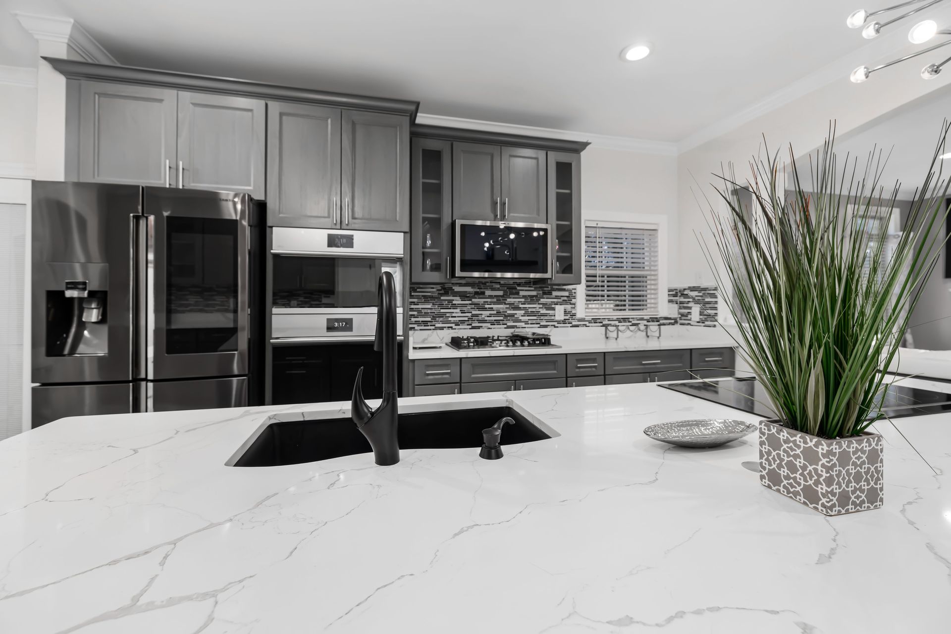 A newly remodeled kitchen with marble countertops