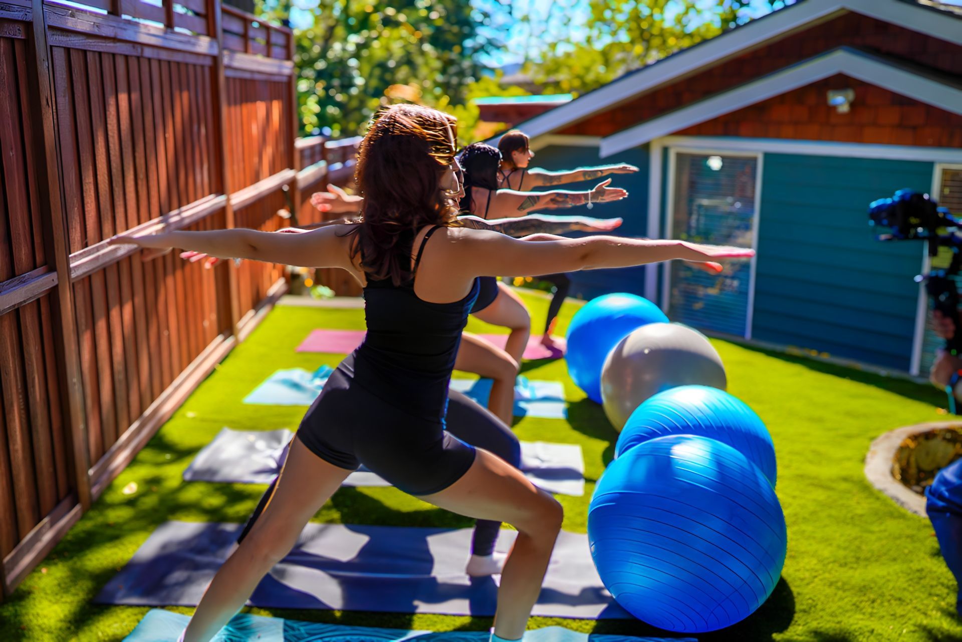 A group of people are doing yoga in front of a house.