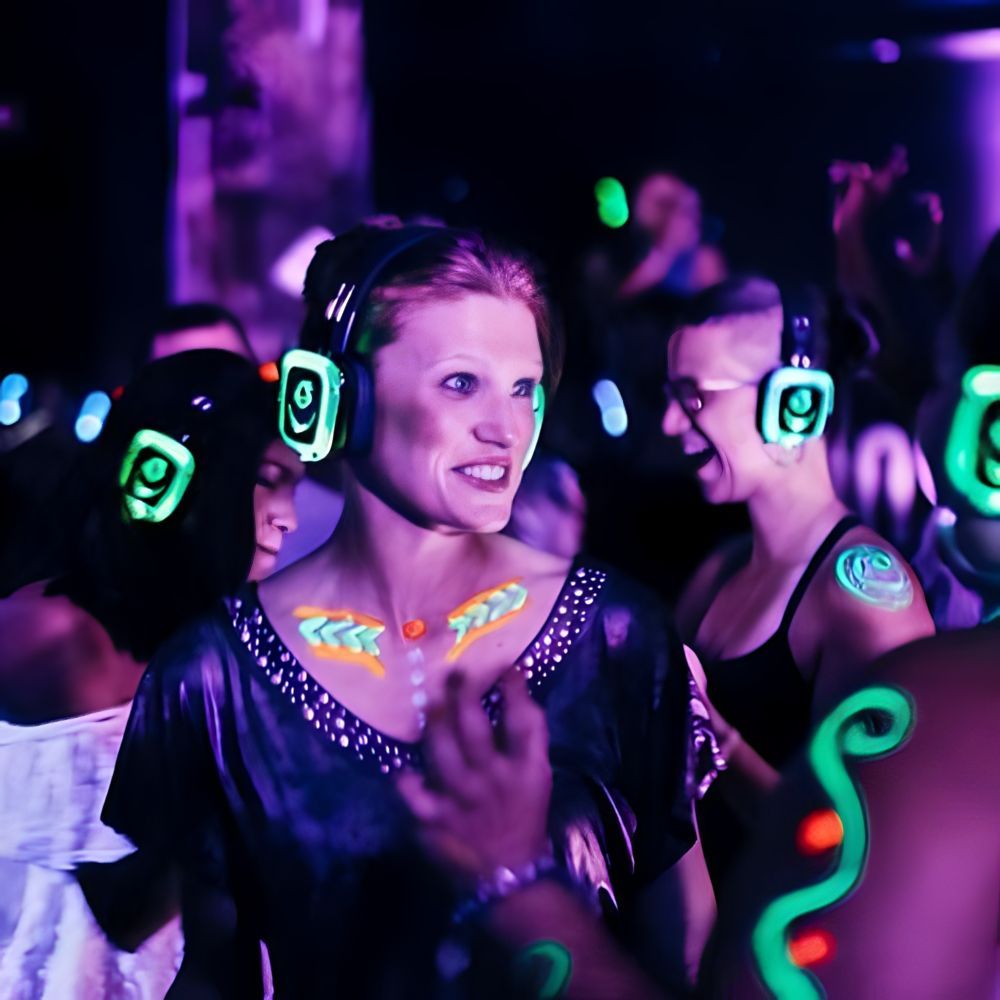A group of people wearing glow in the dark headphones