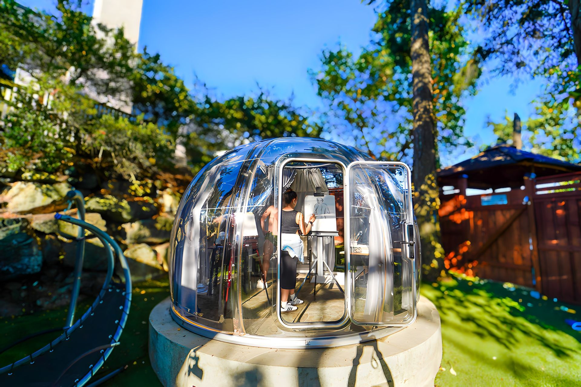 A group of people are standing inside of a clear dome.