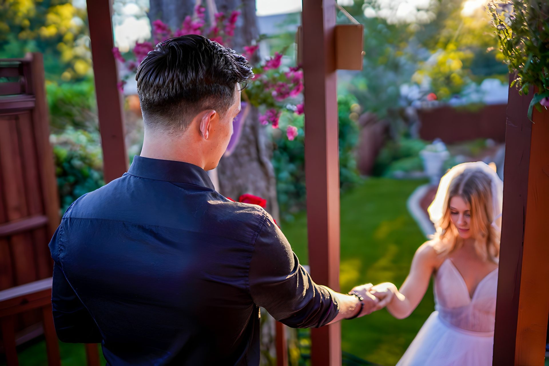 A man is holding the hand of a woman in a white dress.