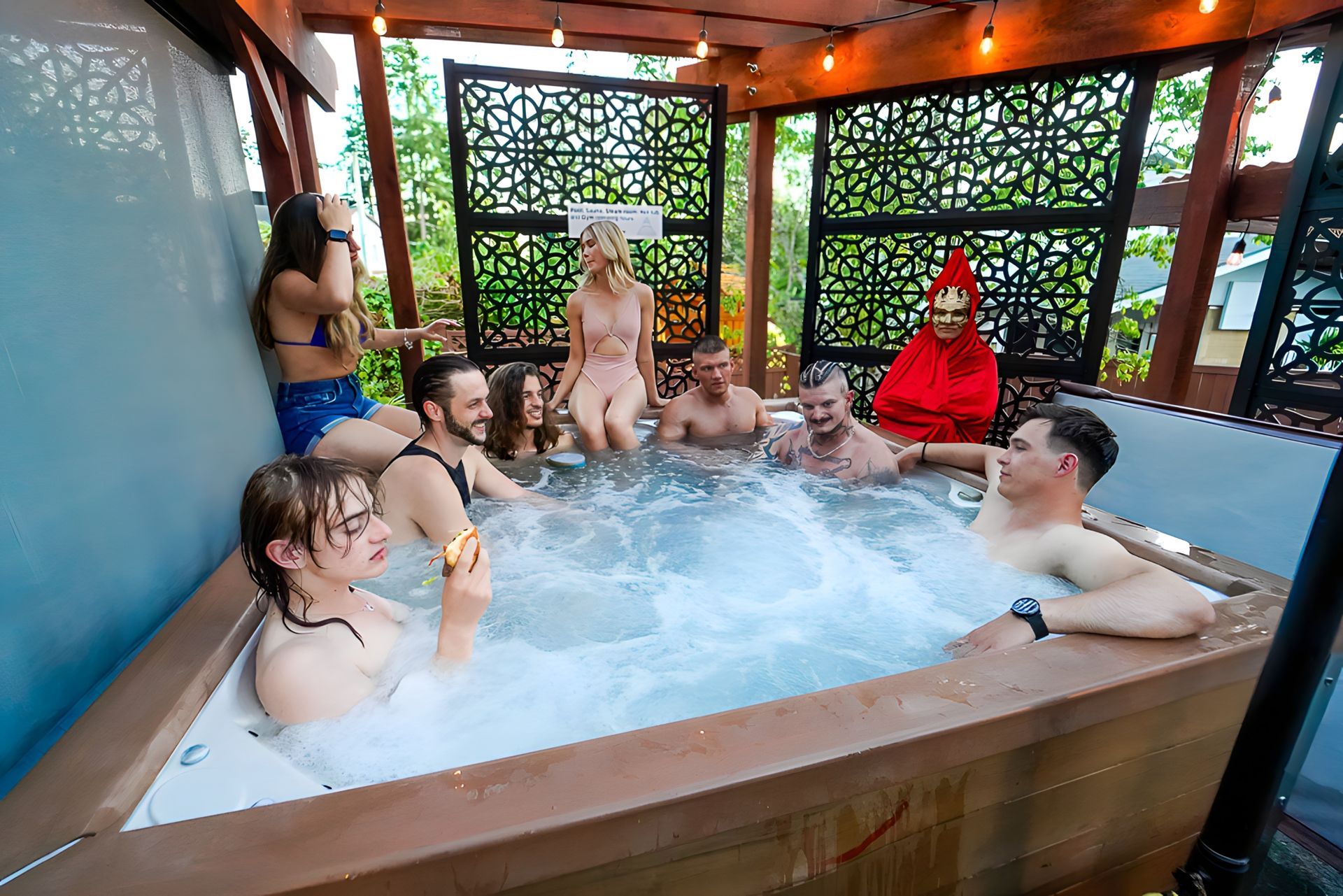A group of people are sitting in a hot tub.