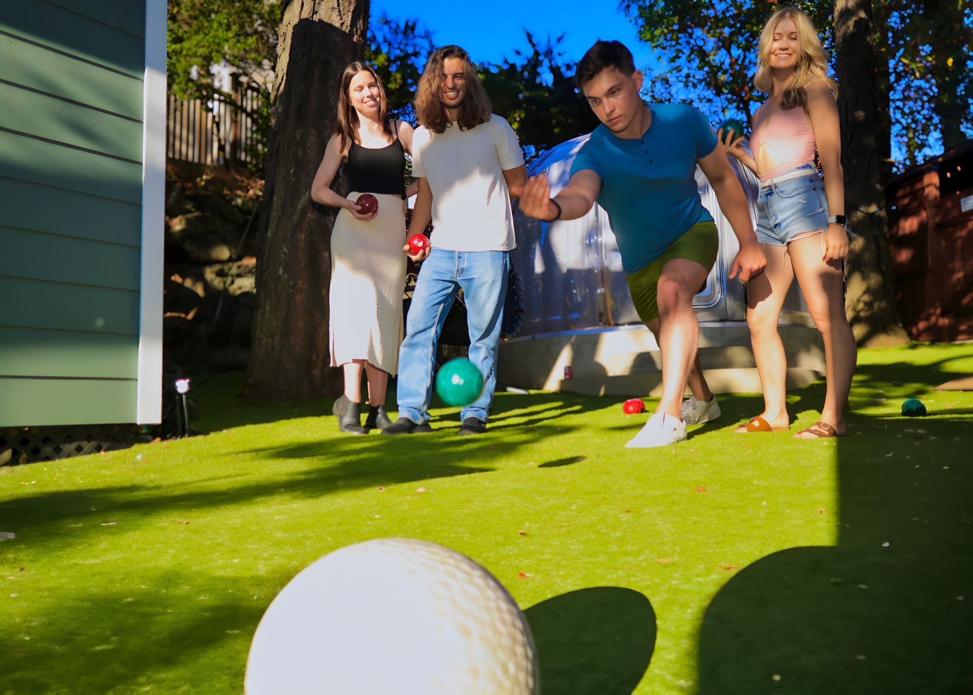 A group of people are playing a game of bocce ball