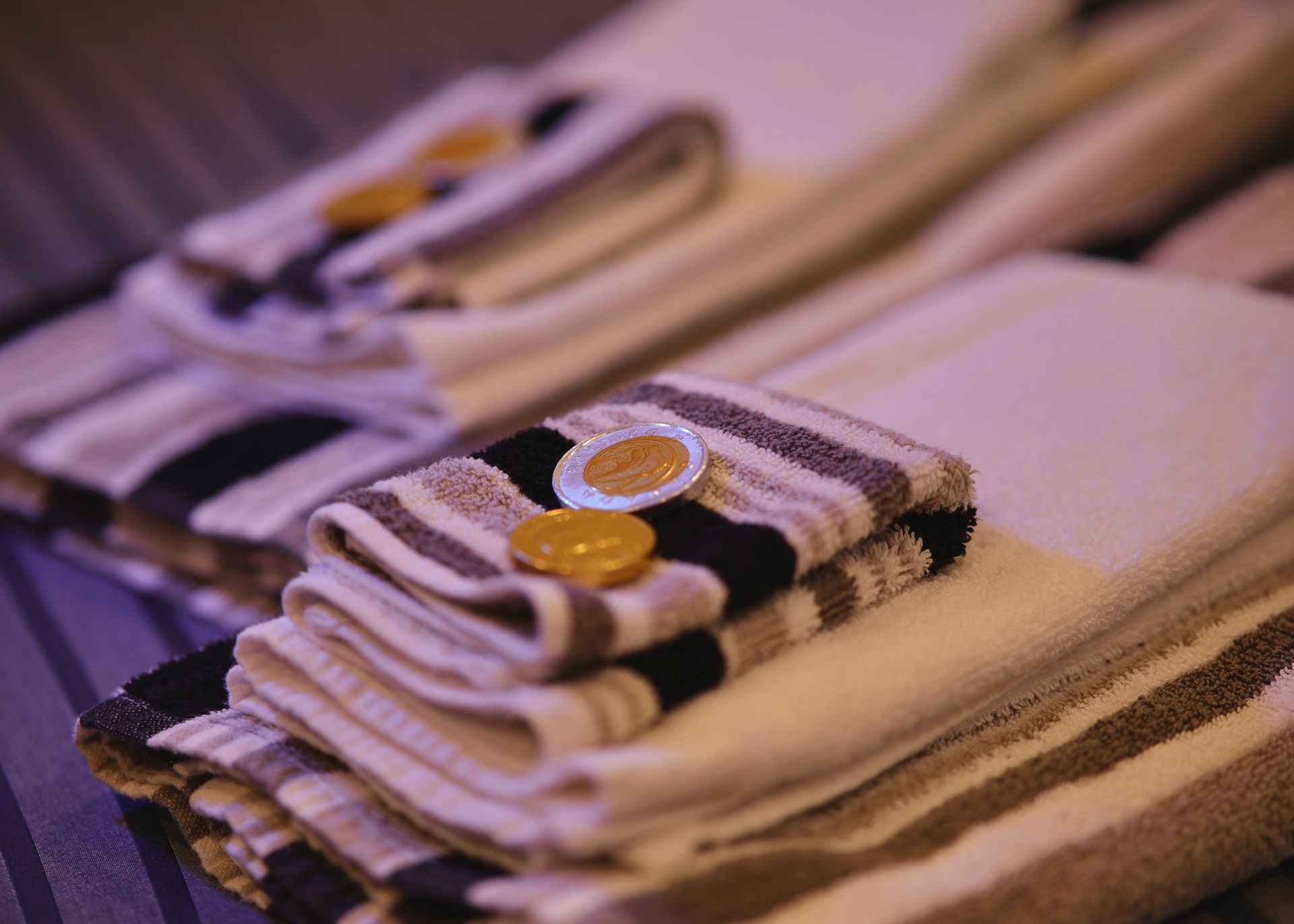 A stack of striped towels with buttons on them
