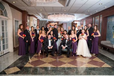 A large group of people are posing for a picture at a wedding.